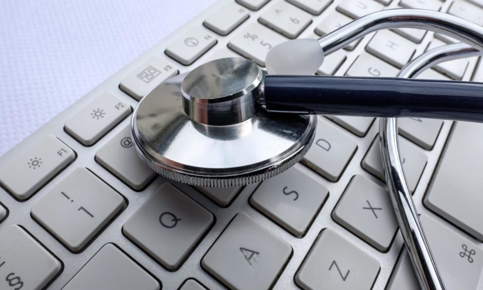 A stethoscope resting on a keyboard