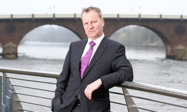 Pete Wishart standing next to bridge in Perth