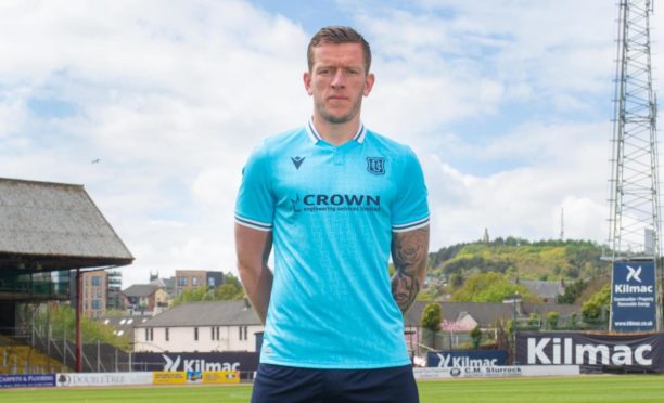 Lee Ashcroft models Dundee's eye-catching new away kit at Dens Park.