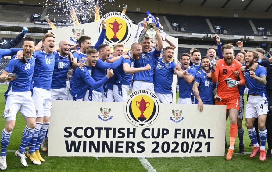 St Johnstone Captain Jason Kerr lifts the Scottish Cup trophy .