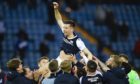 Cammy Kerr is held aloft by team-mates as Dundee won promotion at Kilmarnock.