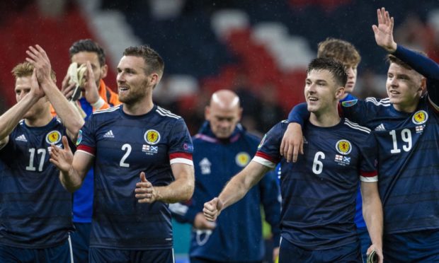 The Scotland players celebrate their draw.