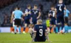 Scotland striker Lyndon Dykes sits dejected on the Hampden turf after the defeat to Croatia.
