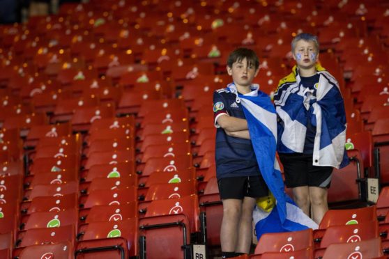 Two young fans watch on as Scotland make an early Euro 2020 exit but Rab Douglas is convinced they'll be back at a major finals soon