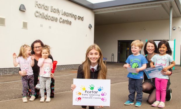 Laura with centre manager Paula Anderson (left), depute manager Lara Turriff and some of the children.