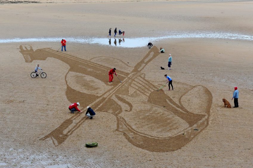 A violin drawn on the sand in East Neuk