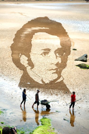 A mural of composer Schubert drawn on the sand at a Fife beach