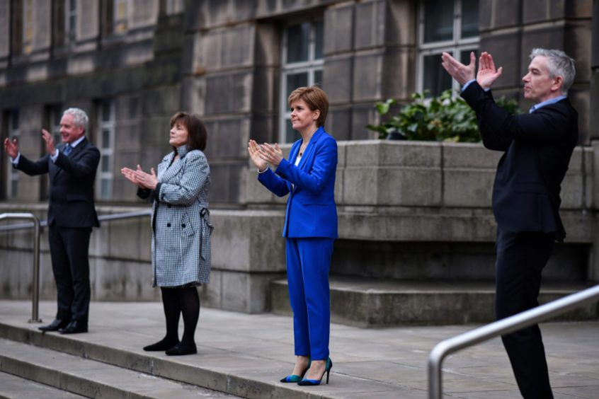 Nicola Sturgeon clapping on the steps of Bute House in Edinburgh.