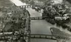 Photo shows aerial view of Perth taken above the River Tay in 1959, facing north with the Ferguson Gallery and rail bridge in the foreground and Smeaton's Bridge in the background.