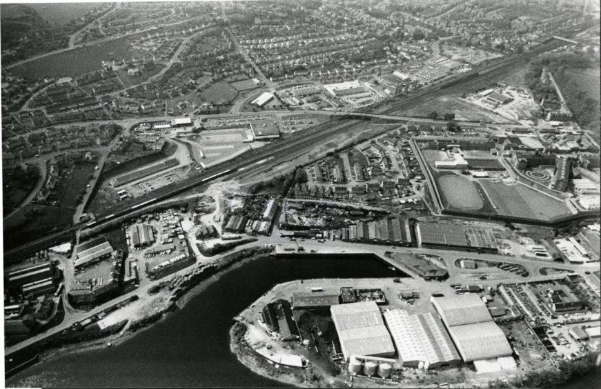 Black and white photo with Perth harbour in foreground and city stretching out behind