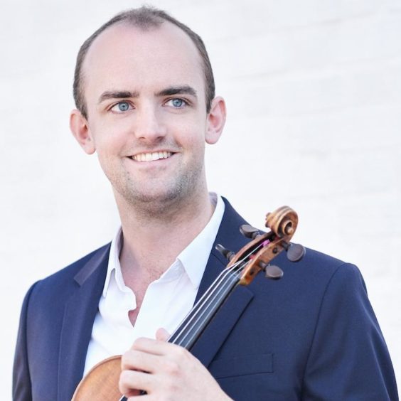 Benjamin Baker posing with his violin