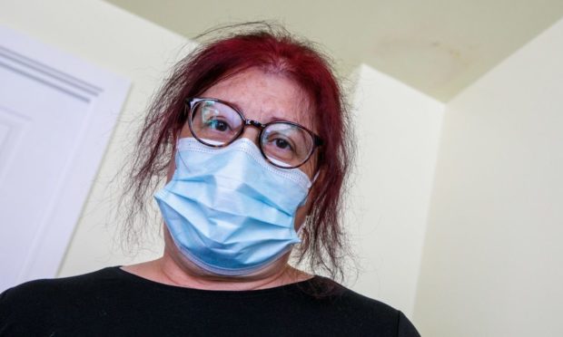 Nan Sutherland with mould on the ceiling of her home