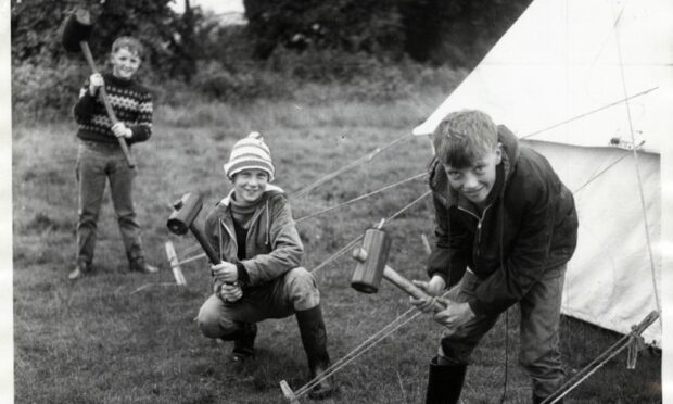 These Dundee lads ensure the guy ropes were firmly in the ground at their company camp in 1968.