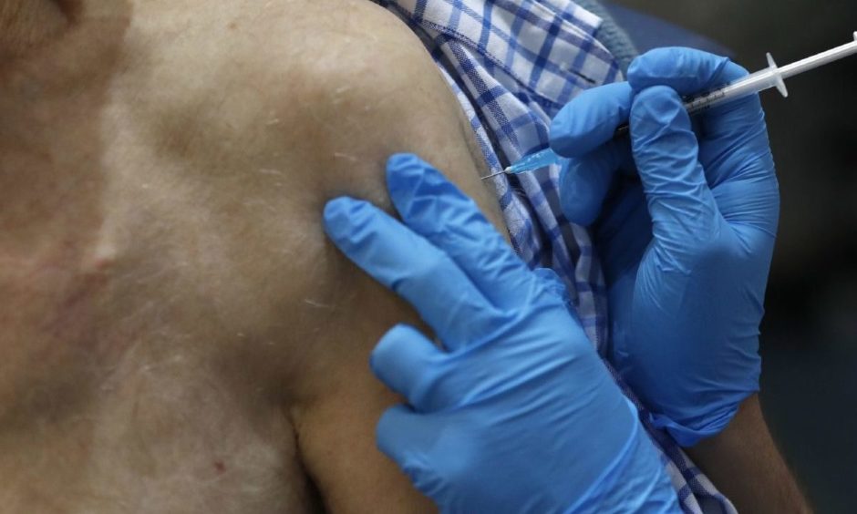 A nurse administers the Pfizer/BioNTech Covid-19 vaccine.