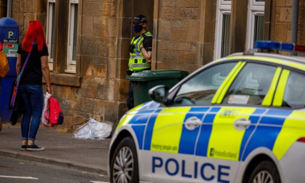 Police at the Scott Street flat in Pert where Mr Menzies was found