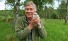 Keith Broomfield holding a kestrel chick