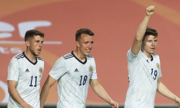 Scotland's Kevin Nisbet celebrates with  his team-mates after scoring.