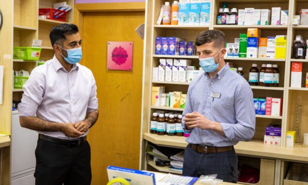 Health Secretary Humza Yousaf and Michael Anderson, deputy manager of McPherson's Pharmacy