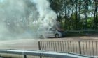 The campervan on fire.