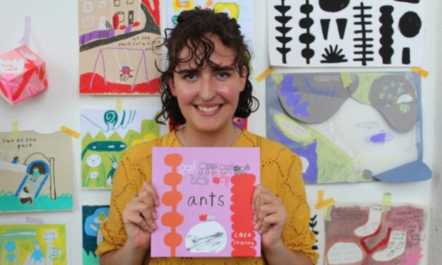 Cara Rooney holds her book Ants