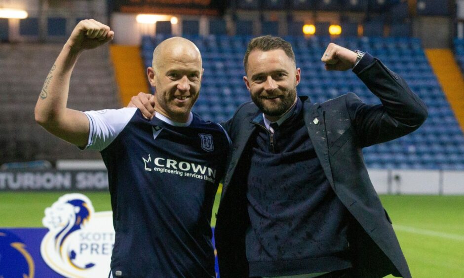 Charlie Adam and James McPake celebrate following Dundee's play-off triumph.