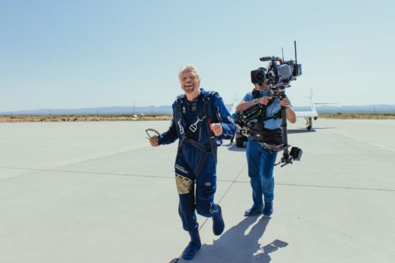 Sir Richard  Branson runs to hug his family after landing from space Unity22.