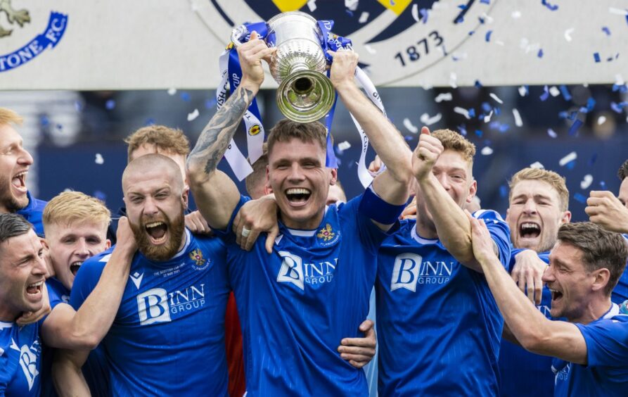 Then St Johnstone captain Jason Kerr lifts the Scottish Cup.