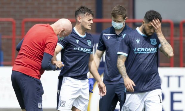 Dundee's Danny Mullen (centre) receives treatment against West Ham.