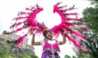 Carnival performer Monique Hendry displays one of the vibrant carnival costumes at the launch of the Edinburgh Festival Carnival 2021 which is set run from Friday July 16 to Sunday July 18. Jane Barlow/PA Wire