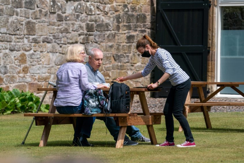 Visitors to the House of Dun enjoying a sunny snack.