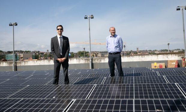 SNP councillors John Alexander and Mark Flynn on the roof of Gellatly Car Park with solar panels.