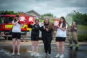 Ian Rooke of Montrose fire station with young volunteers at the town's Poppy Scotland charity car wash.