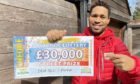 People's Postcode Lottery ambassador Danyl Johnson with a cheque for £30,000.