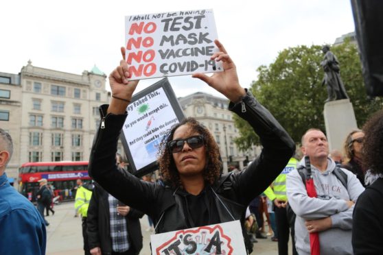 Anti-mask, anti-lockdown and anti-vaccine protesters stage a demonstration in Trafalgar Square.