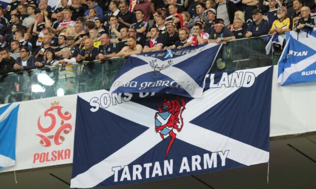 Scottish supporters with flags in the stands of the National Stadium in Warsaw.
