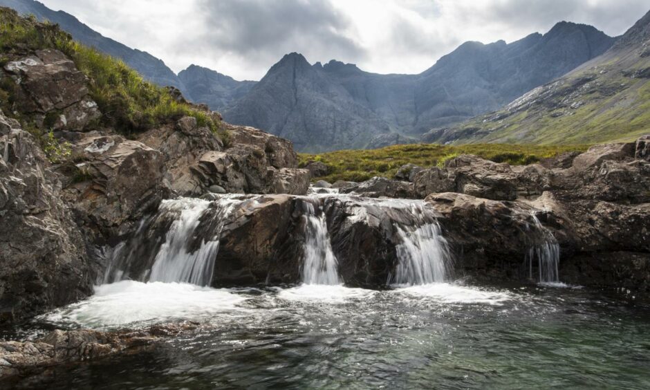Waterfall at the Fairy Pools in Glen Brittle with the Cuillin mountains behind, Isle of Skye.