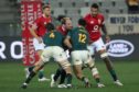 Lions captain Alun-Wyn Jones is double tackled as he tries to carry.