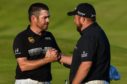 Leader Louis Oosthuizen is congratulated by defending champion Shane Lowry.
