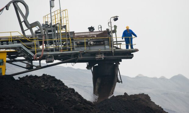 A bucket chain excavator mines lignite in the open-cast mine of Vattenfall AG in Jaenschwalde, Germany