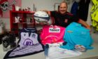 Brechin Rugby Club chairman Mike Reid with some of the lots in a silent auction being run for club funds. Pic: Paul Reid