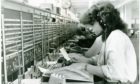 A radio-telephone operator at work in a Dundee office in July 1980.