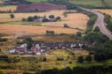 View od Oudanarde site, with some houses and the M90 motorway running alongside.