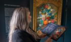 Kirsty McKay (Activity Engagement Officer PKAVS) studies the history of Jan van Huysum's magnificent painting, Flowers in a Terracotta Vase (1736–7) whilst on display at the Walled Garden in the grounds of the Murray Royal Hospital. Picture: Kenny Smith/DCT Media.