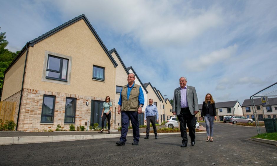 New council houses completed in Scone. From left: Elaine Ritchie, Bob Brawn, John Baggley, Chris Ahern and Nicola Lennon.