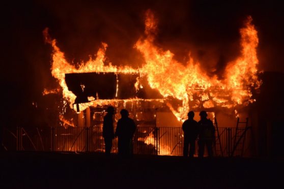 A school building on fire at night