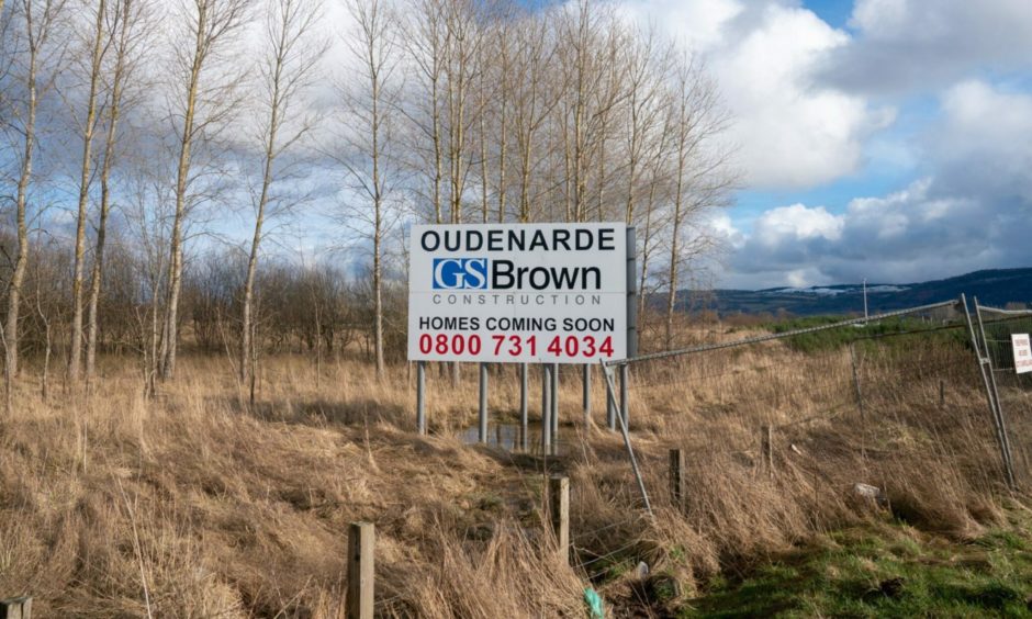 Sign for GS Brown's Oudenarde site on waste ground at Bridge of Earn