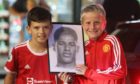 Two young fans with a portrait of Marcus Rashford