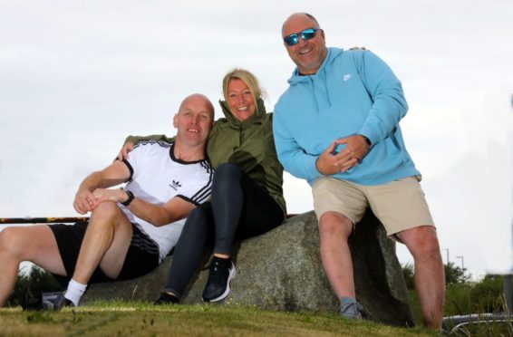 Paul Drummond (51 in white t shirt), Annette Costello (56) & Colin Young (57) are walking from Arbroath to Craigie in Dundee to raise money for Cystic Fibrosis, Paul's daughter Ashley died 10 years ago from cystic fibrosis,