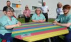 Back, L-R: Richard McIntosh (NHS), Jenny Alexander (NHS employee director), Gary Preston (production officer NHS Tayside), Trudy McLeay (non-executive director with NHS Tayside health board). Front: Laundry staff Jane Livingston, Yvonne Scott and Ciaran Fraser at the outdoor seating.