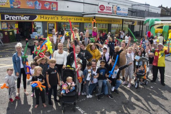 Shop owner Alfie Hayat (centre front) organised the fun day for locals